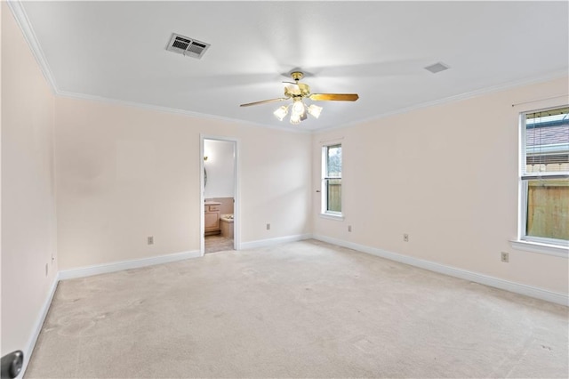 carpeted spare room with ceiling fan and crown molding