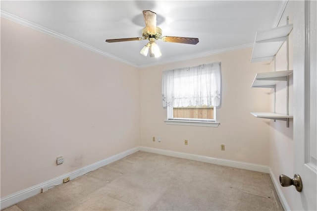 carpeted empty room featuring ceiling fan and crown molding