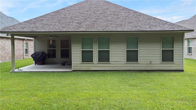 rear view of property featuring a patio, a yard, and ceiling fan