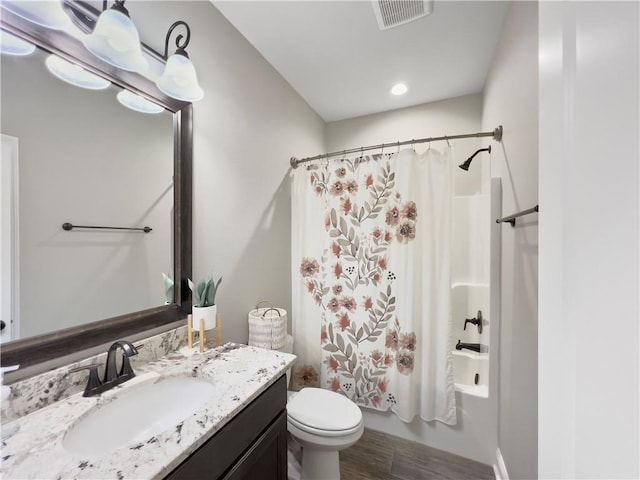 full bathroom featuring shower / bathtub combination with curtain, toilet, vanity, and hardwood / wood-style flooring