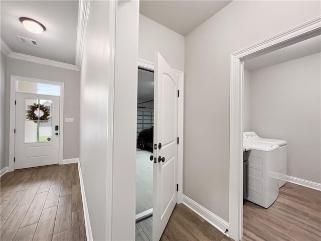 entrance foyer featuring hardwood / wood-style flooring and ornamental molding