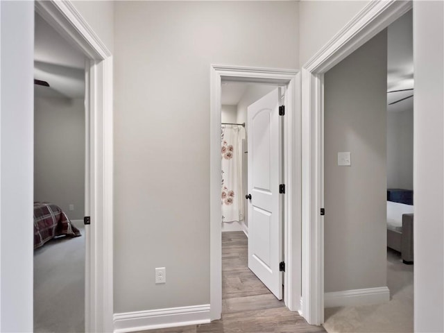 corridor with light hardwood / wood-style flooring