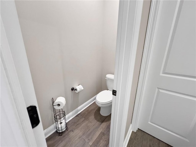 bathroom with wood-type flooring and toilet