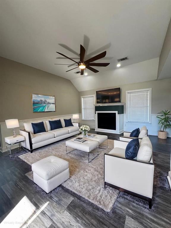 living room featuring ceiling fan, lofted ceiling, and dark hardwood / wood-style floors