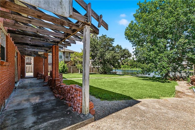 view of yard with a water view and a pergola