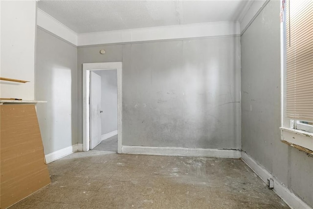 spare room featuring crown molding