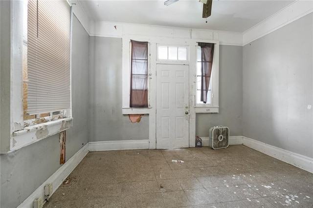 entryway featuring ceiling fan and ornamental molding