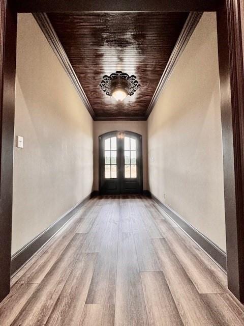 unfurnished room featuring ornamental molding, wood-type flooring, and french doors