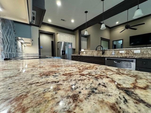 kitchen featuring white cabinets, decorative light fixtures, stainless steel appliances, sink, and ceiling fan