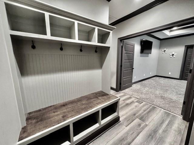 mudroom with crown molding and light hardwood / wood-style flooring