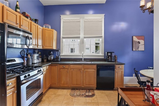 kitchen with light tile patterned floors, stainless steel appliances, and sink