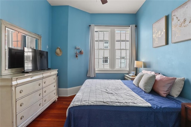 bedroom with ceiling fan and dark hardwood / wood-style flooring