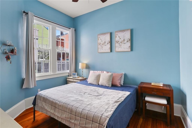 bedroom with dark wood-type flooring and ceiling fan