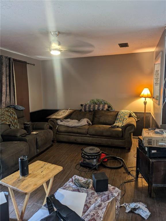 living room featuring ceiling fan and hardwood / wood-style floors