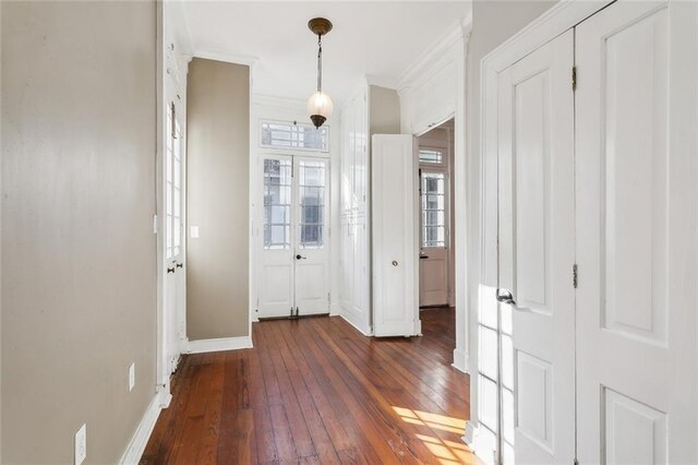 entrance foyer featuring dark wood-type flooring and crown molding