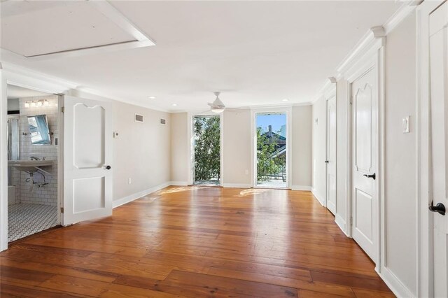 spare room with ceiling fan, wood-type flooring, and crown molding