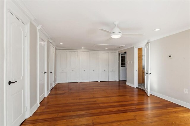 unfurnished bedroom featuring ceiling fan and dark hardwood / wood-style flooring