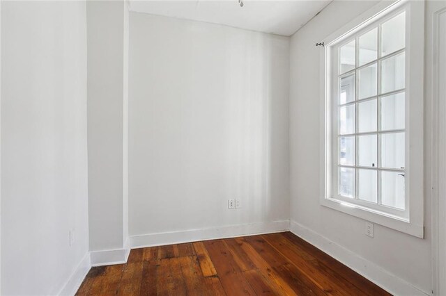 unfurnished room with dark hardwood / wood-style floors