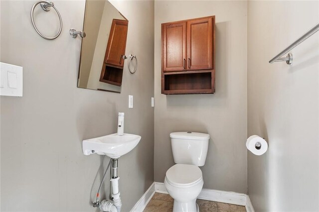 bathroom featuring toilet and tile patterned flooring