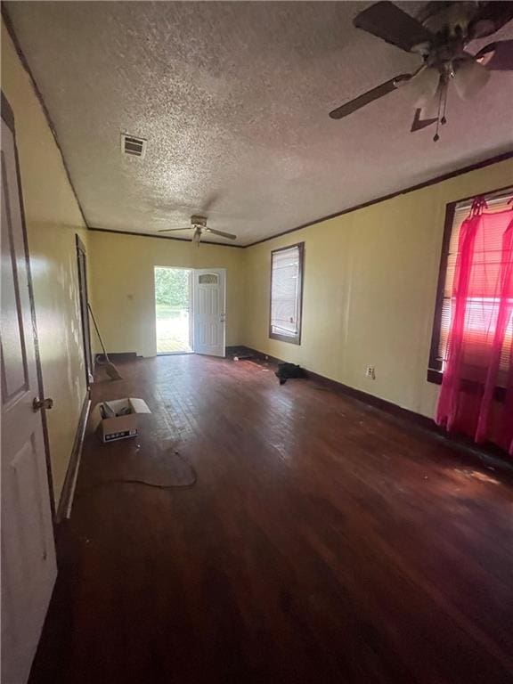 empty room featuring hardwood / wood-style floors, ceiling fan, and a textured ceiling