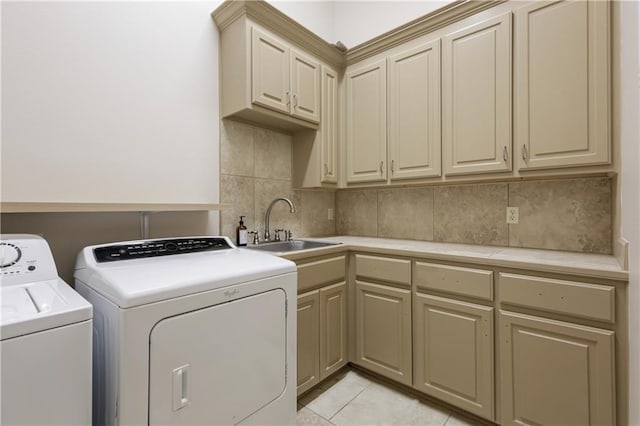 laundry room with cabinets, sink, washing machine and dryer, and light tile patterned floors