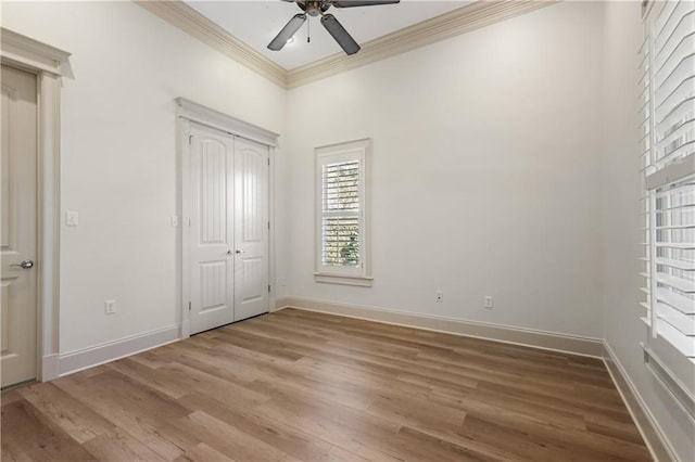 unfurnished bedroom featuring ornamental molding, hardwood / wood-style floors, ceiling fan, and a closet