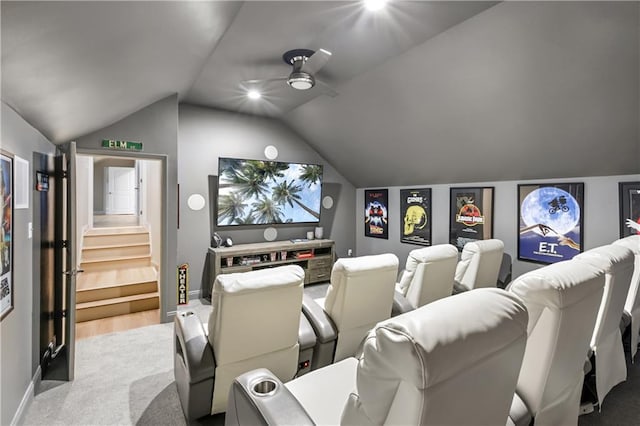 cinema room with vaulted ceiling, ceiling fan, and carpet flooring