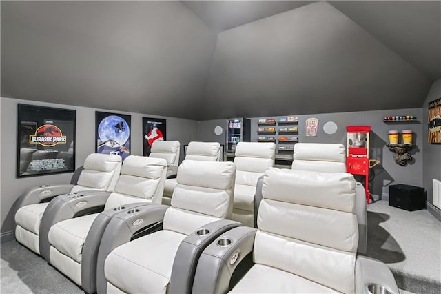 carpeted home theater room featuring vaulted ceiling