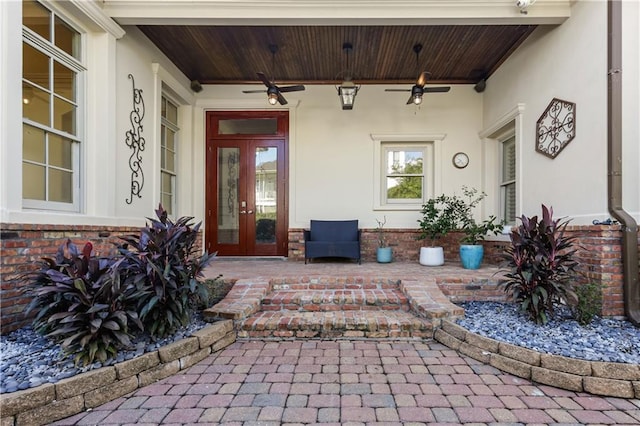 property entrance featuring french doors and ceiling fan