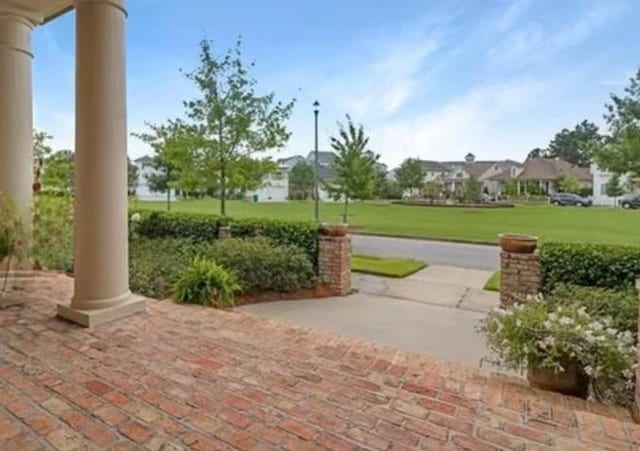 view of community with a patio and a yard