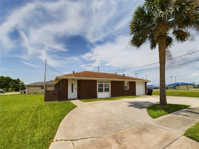 single story home with a front yard and a garage