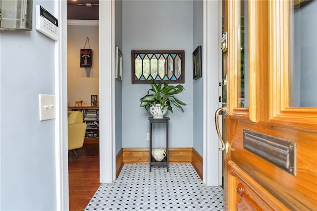 doorway to outside featuring crown molding