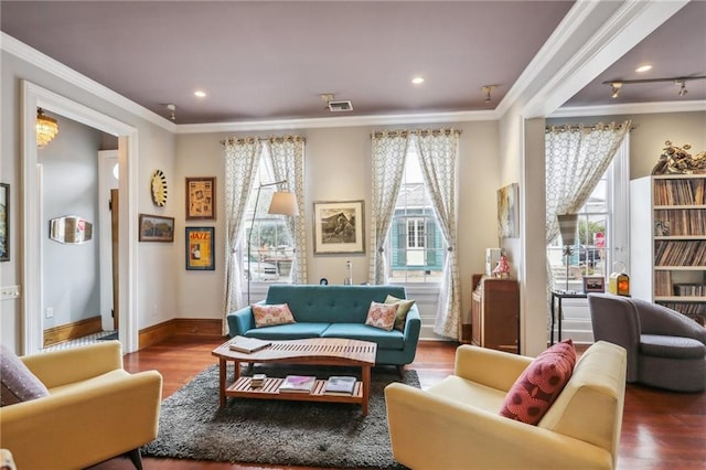 living area with wood-type flooring and ornamental molding