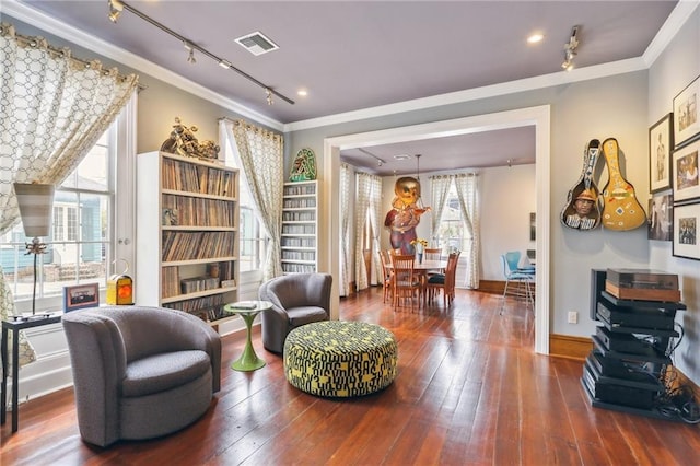 living area featuring hardwood / wood-style flooring and ornamental molding