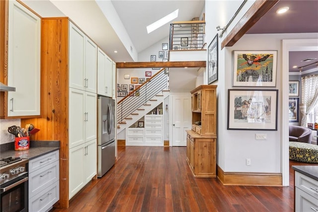 kitchen featuring appliances with stainless steel finishes, dark wood-type flooring, and white cabinets