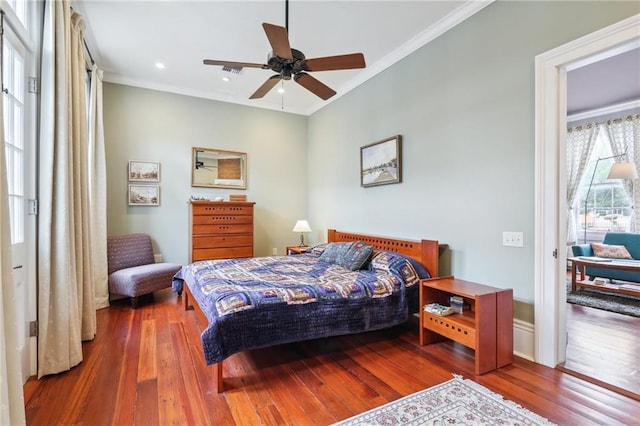 bedroom featuring crown molding, wood-type flooring, and ceiling fan