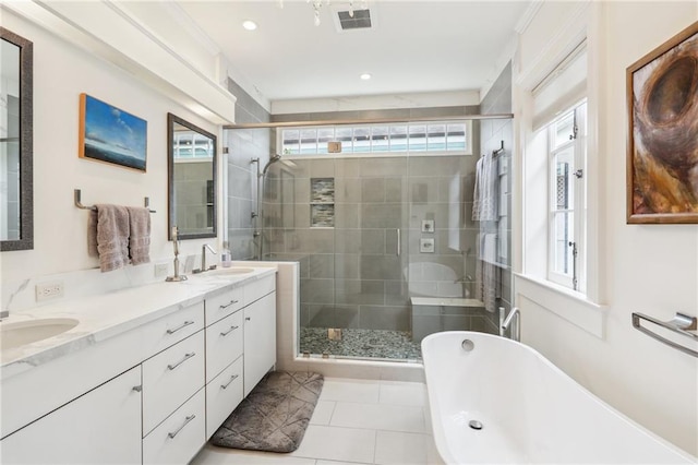 bathroom featuring tile patterned floors, separate shower and tub, and vanity