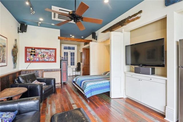 bedroom featuring stainless steel refrigerator, rail lighting, ceiling fan, dark wood-type flooring, and french doors