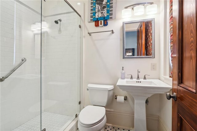 bathroom featuring walk in shower, toilet, and sink