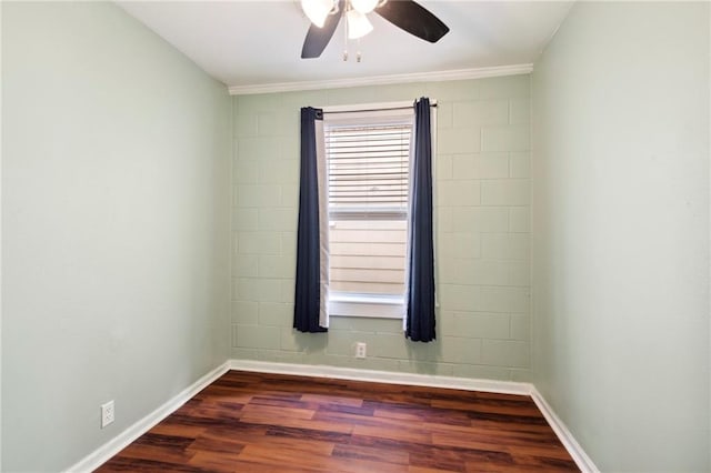 empty room with crown molding, ceiling fan, and dark hardwood / wood-style floors