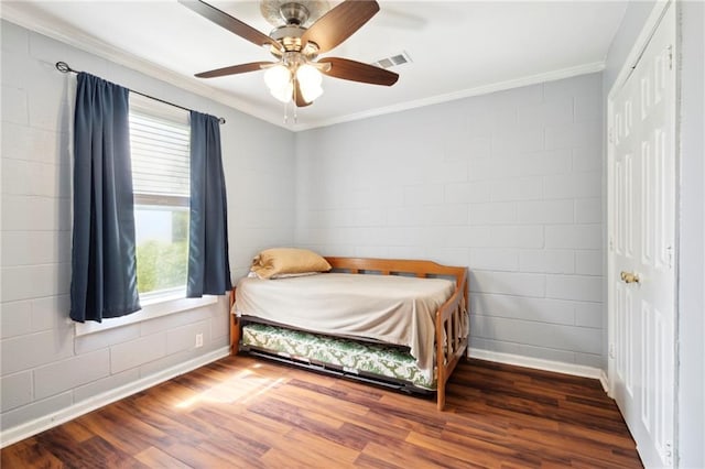 bedroom with dark wood-type flooring, ceiling fan, and ornamental molding