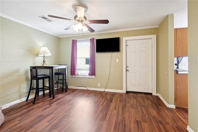 interior space featuring dark wood-type flooring, ceiling fan, and ornamental molding