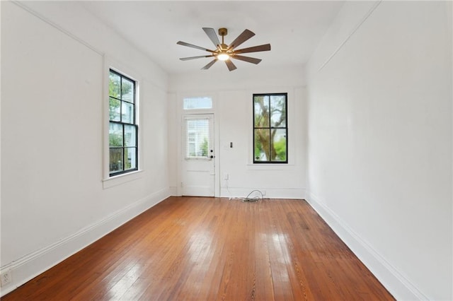 unfurnished room with hardwood / wood-style floors and ceiling fan