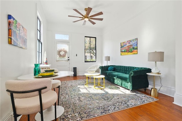 living room featuring hardwood / wood-style floors and ceiling fan