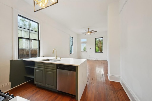 kitchen with stainless steel dishwasher, dark hardwood / wood-style floors, kitchen peninsula, and sink