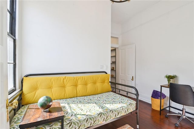 bedroom with dark hardwood / wood-style floors