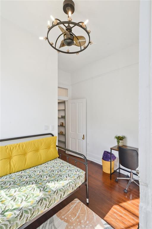 bedroom featuring an inviting chandelier and hardwood / wood-style floors