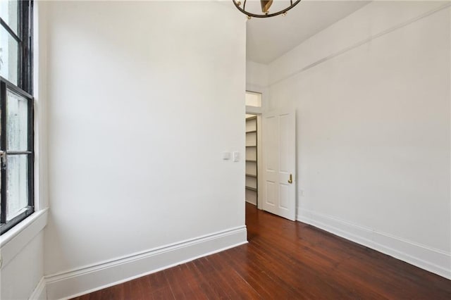 unfurnished room featuring dark hardwood / wood-style flooring