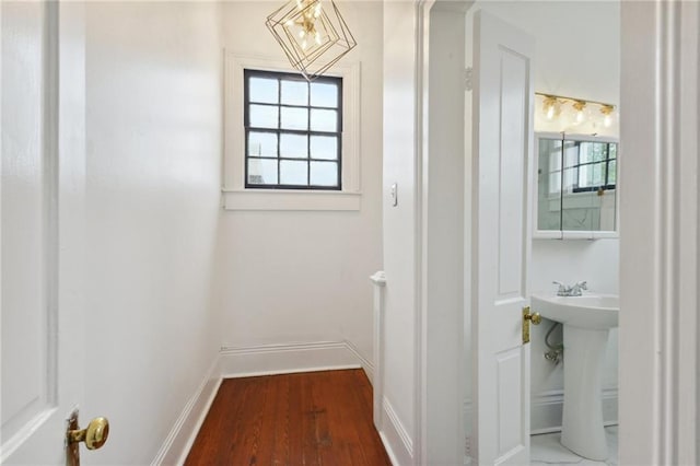 bathroom with sink, hardwood / wood-style flooring, and a healthy amount of sunlight