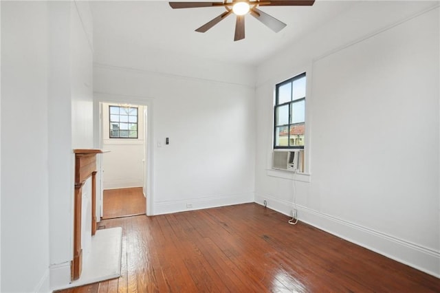 spare room featuring cooling unit, ceiling fan, and hardwood / wood-style floors